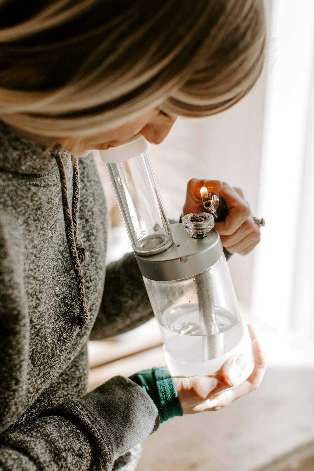 a woman is holding a water dispenser in her hands
